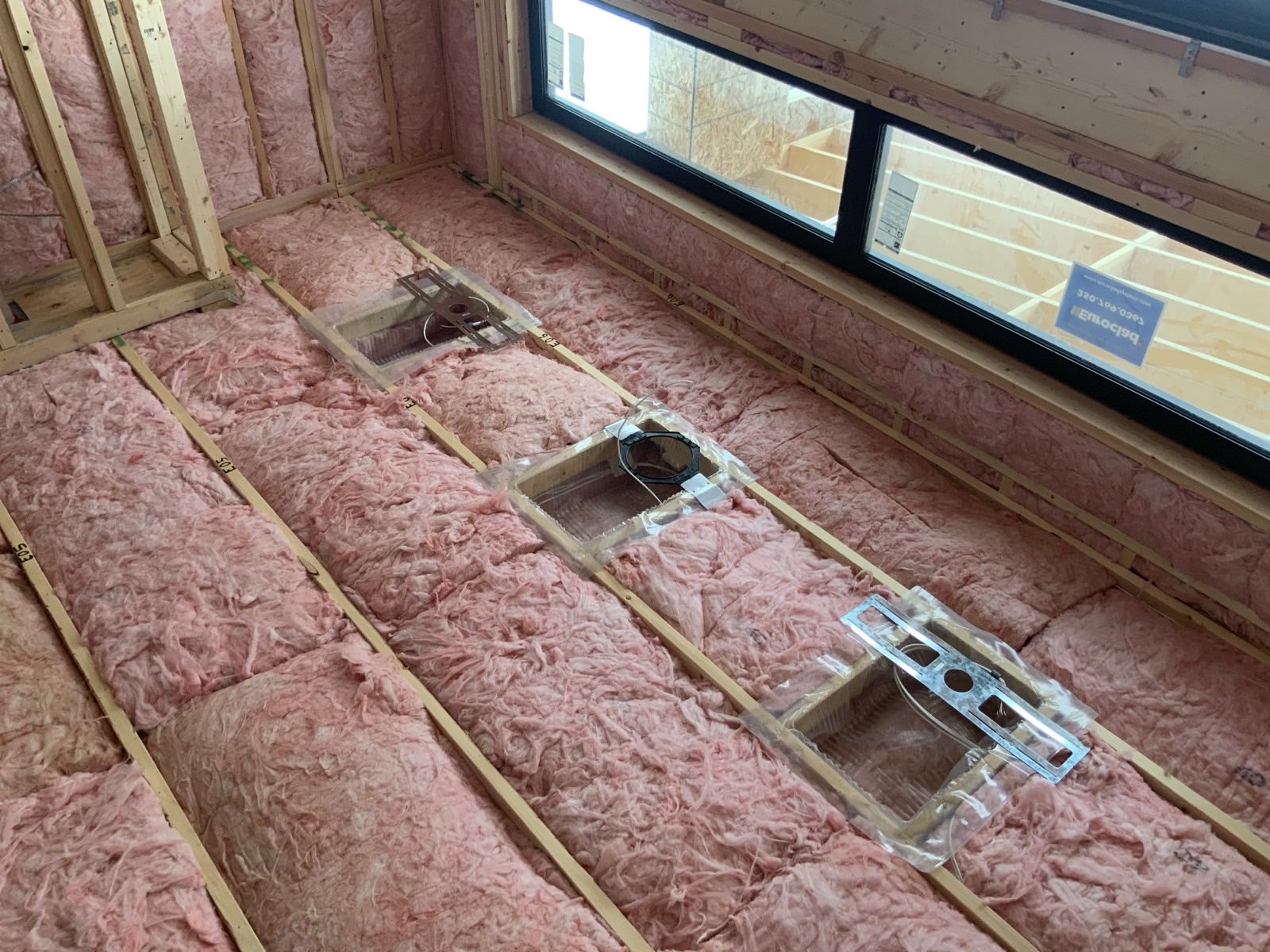 Insulation and framing at a new construction inspection.